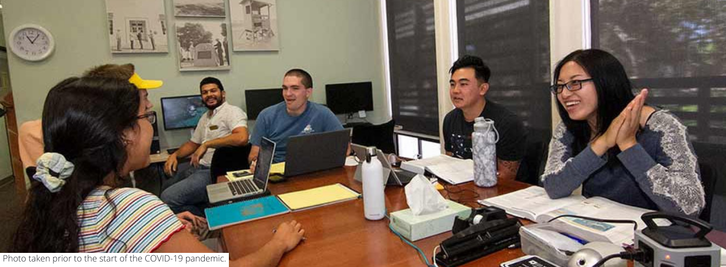 Peer navigators and students talk inside the Student Veterans Resource Center at UC San Diego