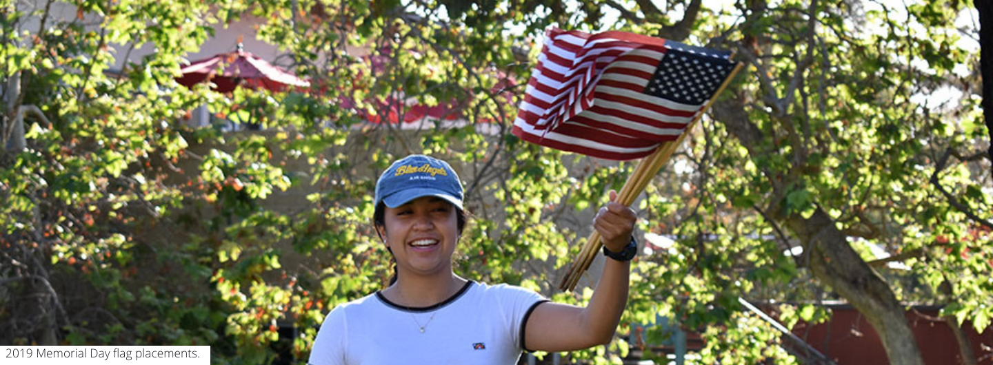 UC San Diego student from Student Veterans Resouce Center, waiving the flag of the United States